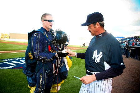 US Navy 100318-N-3271W-116 Special Warfare Operator 1st Class Isaiah Maring (SEAL) presents the game ball to New York Yankees coach Ron Guidry before a pre-season game with the Tampa Bay Rays at Steinbrenner Field