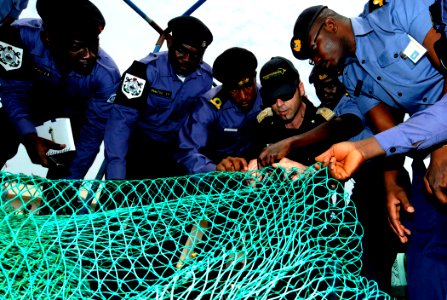 US Navy 100315-N-7948C-177 talian navy Lt. Federico Panconi shows an example of a properly constructed fishing net to Nigerian and Ghanaian sailors photo