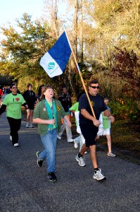 US Navy 100313-N-5366K-048 Special Warfare Operator 1st Class (SEAL) Aaron Darakjy carries the guidon for Girl Scout Troop 207 during the Walk with the Mayor photo