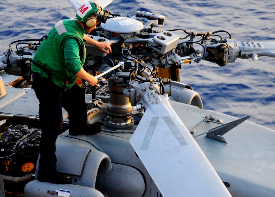 US Navy 100318-N-7508R-080 A Sailor assigned to Helicopter Sea Combat Squadron (HSC) 9 performs maintenance on an MH-60s Sea Hawk helicopter