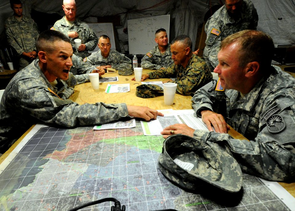 US Navy 100316-N-5961C-003 Lt. Col. David Doyle briefs Lt. Gen. Ken Keen on the internally displaced persons camps that are in his area of responsibility