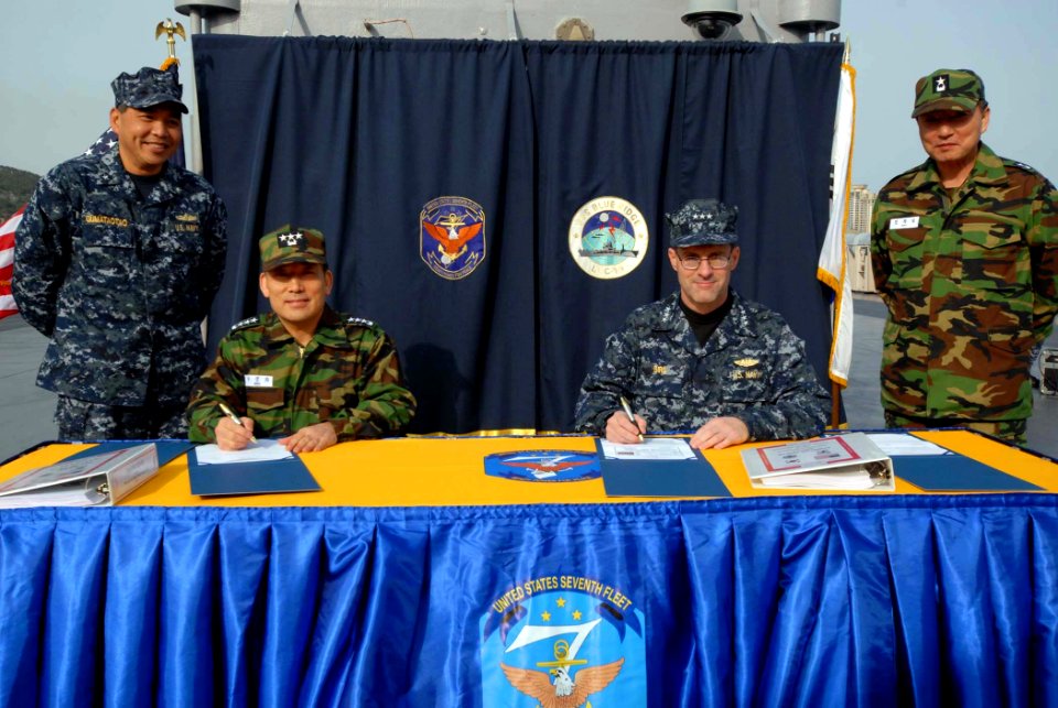 US Navy 100319-N-5086M-076 Vice Adm. John Bird, commander of U.S. 7th Fleet, and Vice Adm. Park, Jung-Hwa, commander of the Republic of Korea Fleet, prepare to sign the Naval Component Base Plan aboard the U.S. 7th Fleet comman