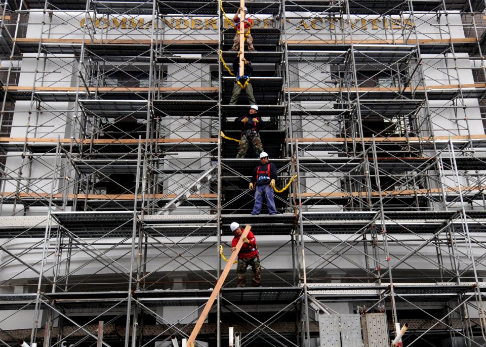 US Navy 100319-N-3283P-002 Contract Japanese workers remove scaffolding after cleaning and painting the facade of the Commander, Fleet Activities Yokosuka headquarters building