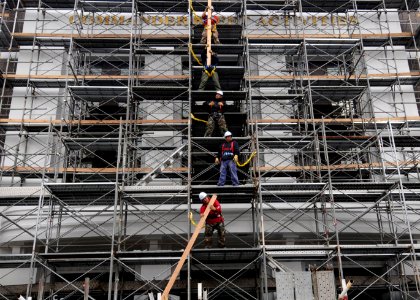 US Navy 100319-N-3283P-002 Contract Japanese workers remove scaffolding after cleaning and painting the facade of the Commander, Fleet Activities Yokosuka headquarters building photo