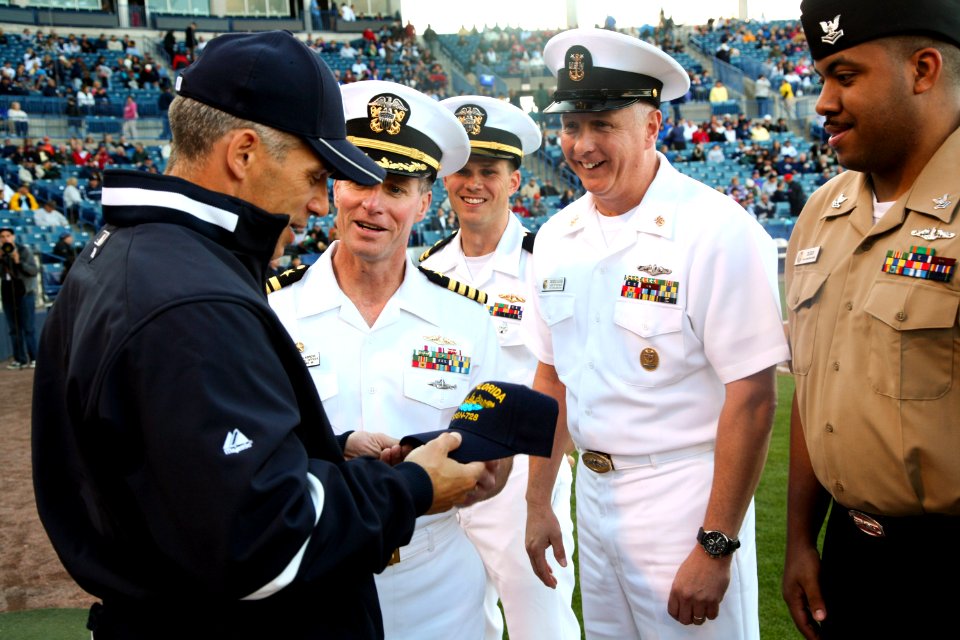 US Navy 100318-N-3271W-142 Crewmembers of USS Florida (SSGN 728) present a ball cap to New York Yankees Manager Joe Girardi