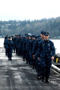 US Navy 100321-N-3038W-085 Sailors aboard the aircraft carrier USS Nimitz (CVN 68) man the rails before arriving at Naval Base Kitsap