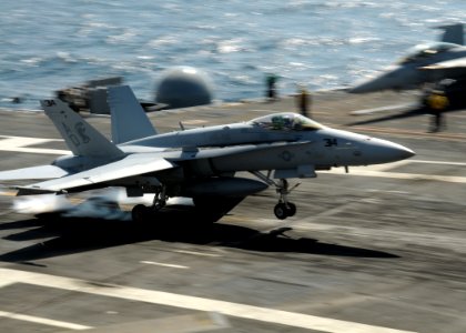 US Navy 100315-N-7908T-635 An F-A-18C Hornet assigned to Strike Fighter Squadron (VFA) 106 lands aboard the aircraft carrier USS George H.W. Bush (CVN 77) during flight operations photo