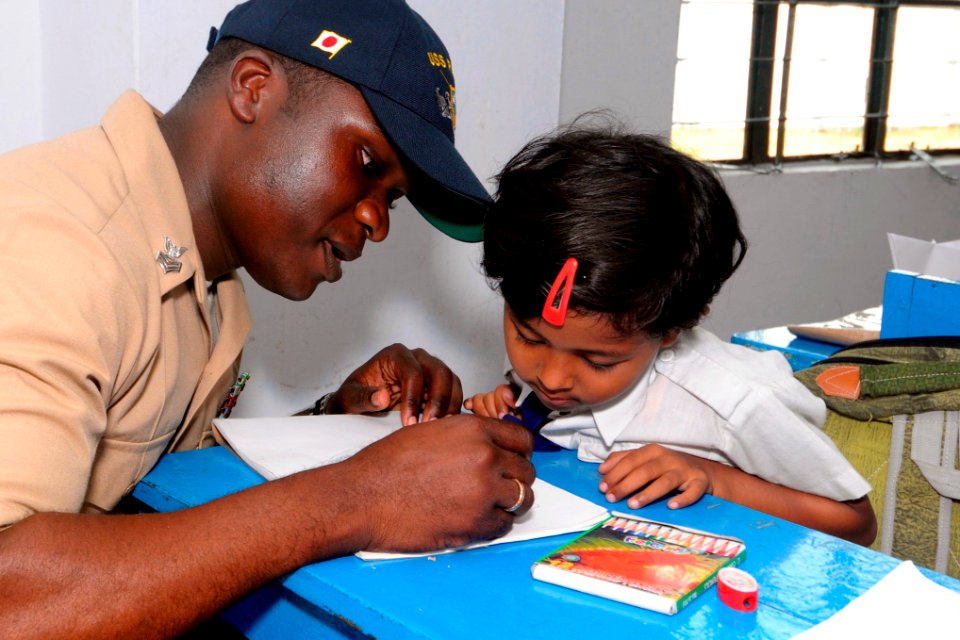 US Navy 100315-N-8335D-125 Logistics Specialist 1st Class Patrick Lampley draws a picture during a community service project at Shishu Niketm-1 elementary school
