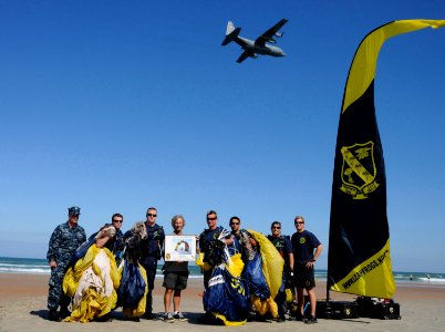 US Navy 100320-N-5366K-103 The Leap Frogs present a signed lithograph to Rob Wallace of the Naval Special Warfare Foundation after the team performed during the kick-off event for the 2010 Daytona Frogman Triathlon photo
