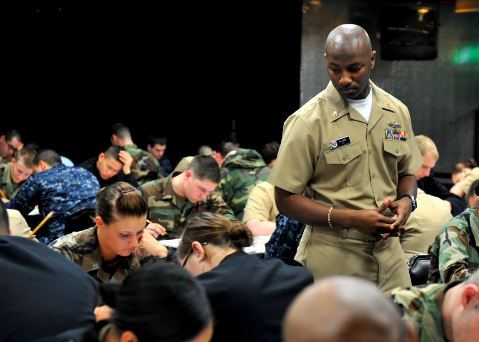 US Navy 100318-N-2013O-006 Chief Logistics Specialist De'Andre Allen, from Jacksonville, Fla., proctors the Navy-wide petty officer 3rd class advancement exam