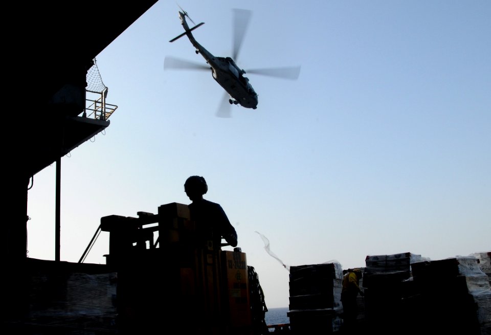 US Navy 100321-N-7508R-048 Sailors aboard the multipurpose amphibious assault ship USS Bataan (LHD 5) transport supplies during an underway replenishment