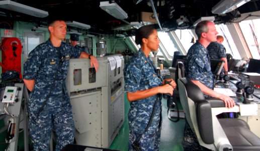 US Navy 100318-N-7058E-062 Cmdr. Randy Garner, commanding officer of the littoral combat ship USS Freedom (LCS 1), looks on as Lt. Cmdr. Jaime Hill and Lt. Todd Sehl maneuver the ship out of the port of Colon
