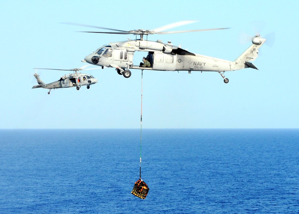 US Navy 100322-N-4649B-216 An MH-60S Sea Hawk helicopter assigned to Helicopter Sea Combat Squadron (HSC) 22 embarked aboard the multipurpose amphibious assault ship USS Bataan (LHD 5) transports ammunition during a vertical re