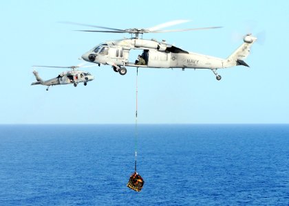 US Navy 100322-N-4649B-216 An MH-60S Sea Hawk helicopter assigned to Helicopter Sea Combat Squadron (HSC) 22 embarked aboard the multipurpose amphibious assault ship USS Bataan (LHD 5) transports ammunition during a vertical re photo