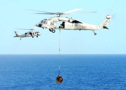 US Navy 100322-N-4649B-216 An MH-60S Sea Hawk helicopter assigned to Helicopter Sea Combat Squadron (HSC) 22 embarked aboard the multipurpose amphibious assault ship USS Bataan (LHD 5) transports ammunition during a vertical re