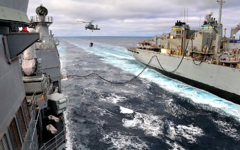 US Navy 100319-N-4774B-355 An SH-60F Sea Hawk helicopter, assigned to the Red Lions of Helicopter Anti-submarine Squadron (HS) 15, carries supplies to the guided-missile cruiser USS Bunker Hill (CG 52)