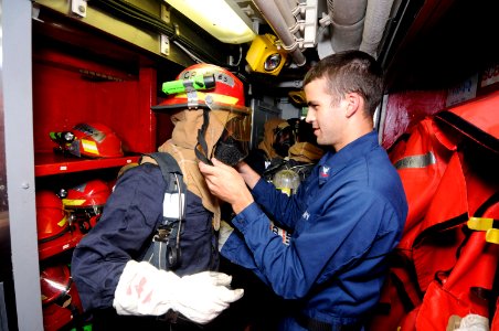 US Navy 100318-N-8335D-256 Mineman 2nd Class Corey Swartz, right, helps a Bangladesh navy sailor put on his firefighting gear during a drill aboard the mine countermeasures ship USS Patriot (MCM 7)
