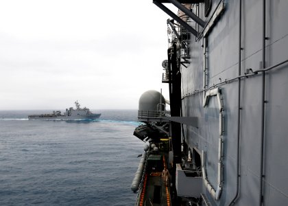 US Navy 100322-N-7948R-146 The amphibious dock landing ship USS Pearl Harbor (LSD 52) trails the amphibious assault ship USS Peleliu (LHA 5) off the coast of Southern California