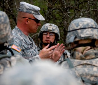 US Navy 100322-N-6932B-394 Lt. Cmdr. Raul Barrientos listens as Staff Sgt. David Garland, an Army drill instructor, critiques a convoy training evolution during the U.S. Navy Individual Augmentee Combat Training course at Fort