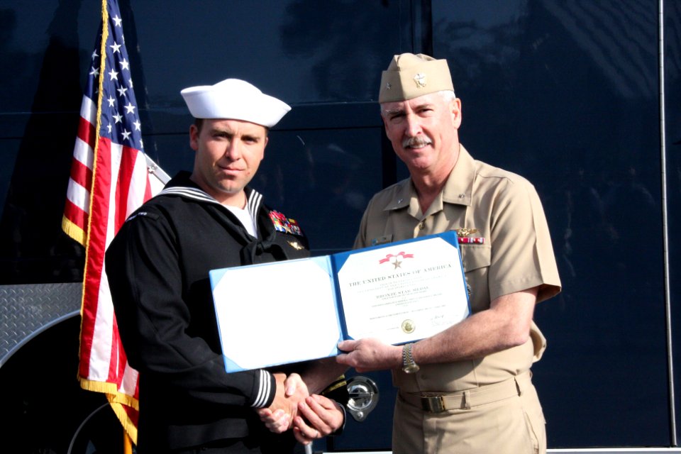 US Navy 100318-N-6936D-024 Rear Adm. Tim Alexander, commander of Navy Region Southeast, presents the Bronze Star medal to Explosive Ordnance Disposal Technician 1st Class Jason Miller