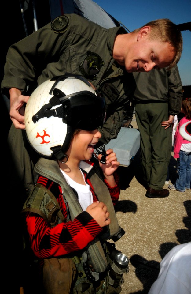 US Navy 100323-N-1522S-004 Aviation Warfare Systems Operator 1st Class Matt Jirrels gives students from Ponte Vedra Elementary school a tour of a helicopter