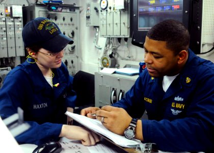 US Navy 100320-N-4649B-019 Chief Machinist's Mate Angel Delacruz, from New York, and Fireman Ashley Haxton, from Port Charlotte, Fla., review logs in the forward main machinery room