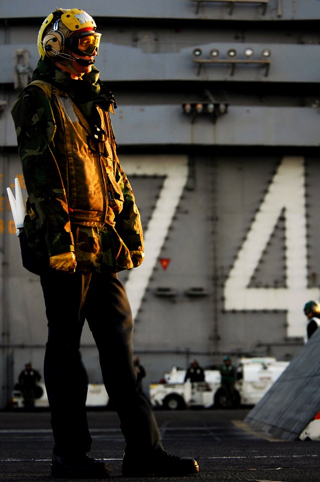 US Navy 100319-N-6538W-361 Aviation Boatswain's Mate (Handling) Airman Nathan Wuiff, from Sugarland, Texas, directs an aircraft aboard the Nimitz-class aircraft carrier USS John C. Stennis (CVN 74)