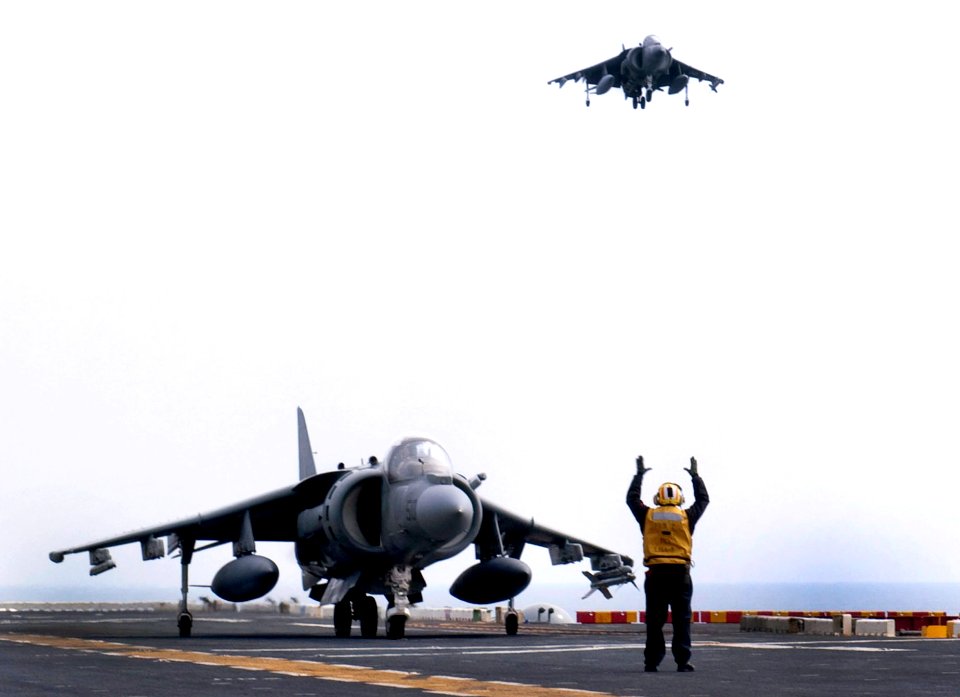US Navy 100321-N-1226D-029 Aviation Boatswain's Mate (Handling) 1st Class Jeremy Fairman taxis an AV-8B Harrier aboard the amphibious assault ship USS Peleliu (LHA 5)