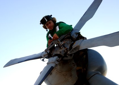 US Navy 100320-N-4649B-147 Aviation Machinist's Mate 1st Class Andrew Van Norman, from Yucaipa, Calif., conducts maintenance on a tail rotor head aboard the multipurpose amphibious assault ship USS Bataan (LHD 5)