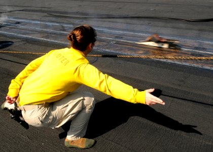 US Navy 100320-N-4236E-148 Lt. Cmdr. Kim Dacosta catapults her boots off the flight deck of USS Dwight D. Eisenhower (CVN 69) to commemorate her last launch aboard the ship
