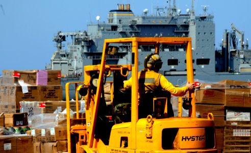 US Navy 100321-N-7508R-559 A Sailor aboard the multipurpose amphibious assault ship USS Bataan (LHD 5) transports supplies during a vertical replenishment