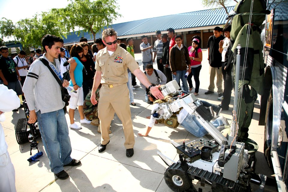 US Navy 100324-N-3271W-051 Chief Explosive Ordnance Disposal Technician Sean O'Leary shows a student at Carl Hayden High School a remote-controlled robot