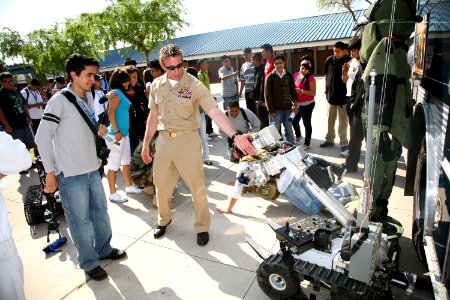 US Navy 100324-N-3271W-051 Chief Explosive Ordnance Disposal Technician Sean O'Leary shows a student at Carl Hayden High School a remote-controlled robot