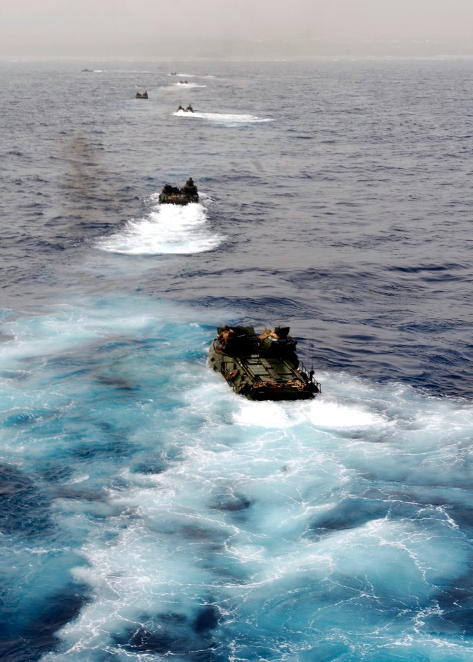 US Navy 100323-N-9950J-168 Amphibious assault vehicles assigned to the 31st Marine Expeditionary Unit (31st MEU) debark the well deck of the amphibious assault ship USS Essex (LHD 2)