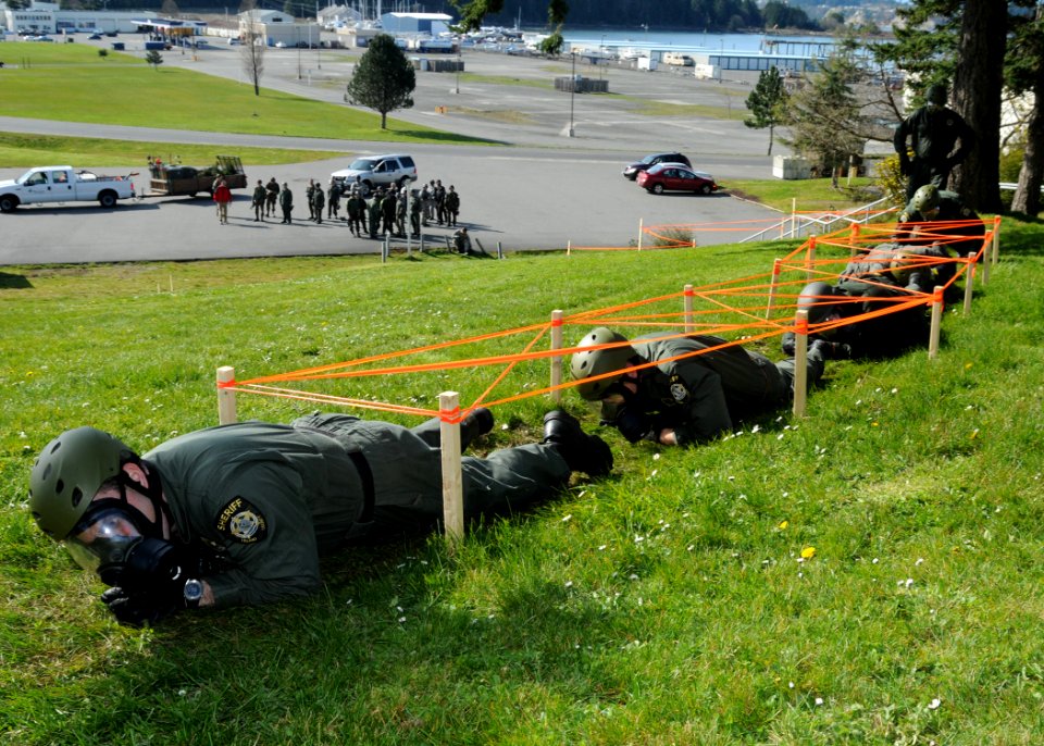 US Navy 100319-N-9860Y-002 Basic Special Weapons and Tactics students complete the Renninger Run during their final team-building exercise on the Naval Air Station (NAS) Whidbey Island Seaplane Base