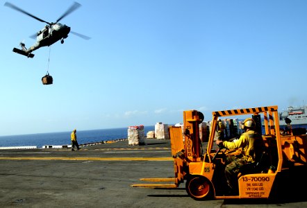 US Navy 100321-N-7508R-295 Sailors aboard the multipurpose amphibious assault ship USS Bataan (LHD 5) prepare to transport supplies during an underway replenishment