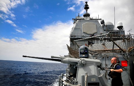 US Navy 100322-N-4774B-120 Sonar Technician (Surface) 3rd Class Drew Collins prepares a MK 38 25mm machine gun for a live-fire exercise aboard the guided-missile cruiser USS Bunker Hill (CG 52)