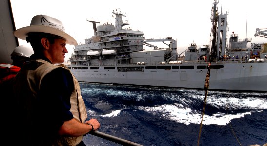 US Navy 100324-N-7948C-192 Ensign Michael Manaski watches as the re-fueling hose from the German navy Type 702 Berlin-class combat support ship Frankfurt Am Main (A 1427) is pulled in photo