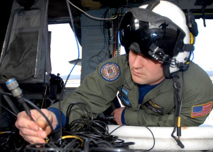 US Navy 100322-N-9520G-001 Naval Air Crewman 2nd Class William Rush, from Houston, assigned to Naval Air Station Whidbey Island Search and Rescue, conducts routine maintenance on an MH-60S Sea Hawk helicopter
