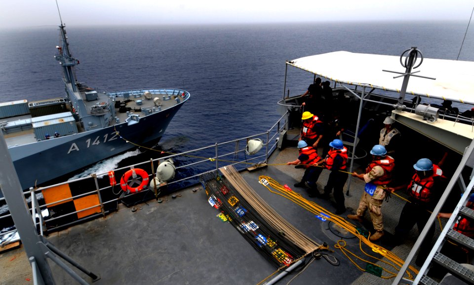 US Navy 100324-N-7948C-286 Sailors assigned the Whidbey Island-class amphibious dock-landing ship USS Gunston Hall (LSD 44) heave on a phone-and-distance line
