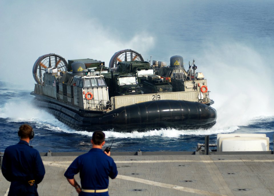 US Navy 100323-N-6692A-055 Sailors observe Landing Craft Air Cushion (LCAC) 29, assigned to Assault Craft Unit (ACU) 5, as it enters the well deck of the amphibious dock landing ship USS Harpers Ferry (LSD 49)