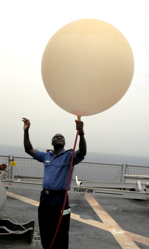 US Navy 100323-N-6676S-011 Nigerian navy Cmdr. Godffrey Kwetishe fills a weather balloon with helium