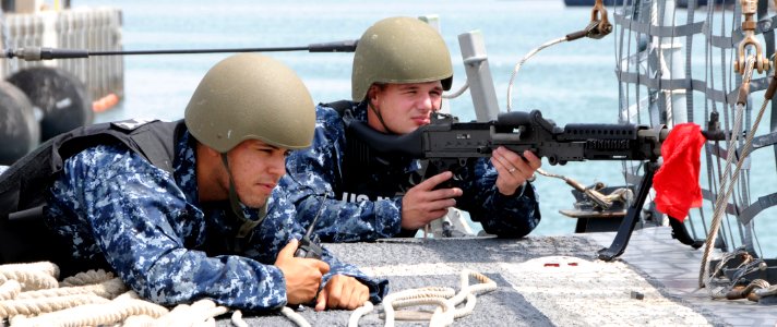 US Navy 100322-N-3666S-049 Boatswain's Mate Seaman Dastin Hernandez, left, and Fire Controlman 2nd Class Adam Conn stand guard with an M-60 machine gun