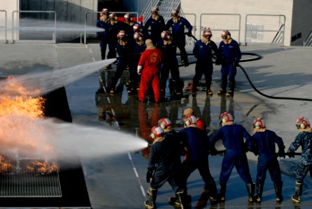 US Navy 100325-N-6552M-042 Sailors and Coast Guardsmen battle a simulated flight deck fire