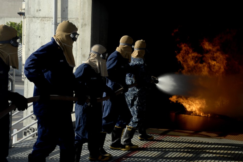 US Navy 100325-N-6552M-083 Sailors and Coast Guardsman put out a controlled fire at the Center for Naval Engineering Site, San Diego.