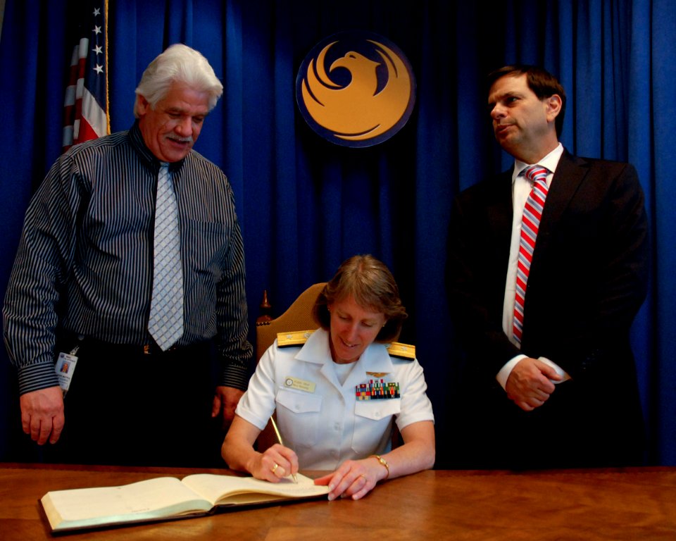 US Navy 100324-N-2389S-072 Rear Adm. Robin Graf, deputy commander of Navy Recruiting Command, signs the official guest ledger Phoenix, Ariz. while visiting Mayor Phil Gordon, right, and Councilman Claude Mattox