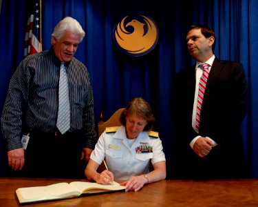US Navy 100324-N-2389S-072 Rear Adm. Robin Graf, deputy commander of Navy Recruiting Command, signs the official guest ledger Phoenix, Ariz. while visiting Mayor Phil Gordon, right, and Councilman Claude Mattox