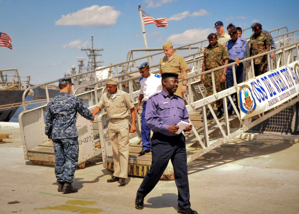 US Navy 100326-N-5812W-001 Senior Chief Quartermaster Michael Howard shakes hands with visitors from foreign navies