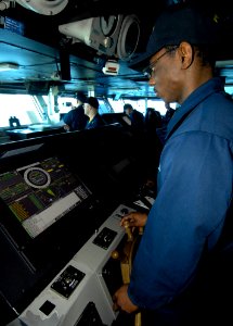 US Navy 100324-N-6362C-142 Boatswain's Mate Seaman Toy Hudson steers the helm on the USS Harry S Truman (CVN 75)