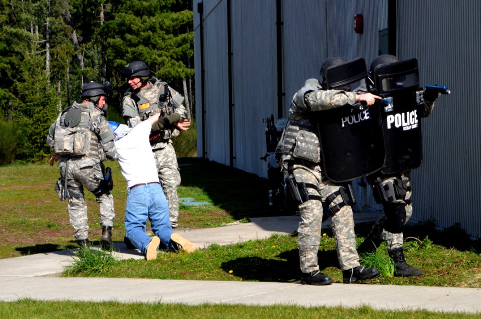 US Navy 100324-N-2143T-002 Members of the Kitsap County Police SWAT team capture a mock terrorist during a simulated hostage situation at Naval Base Kitsap Bangor during the security training exercise Solid Curtain-Citadel Shie
